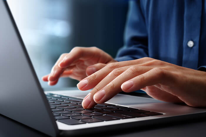 man sitting at desktop computer using apex